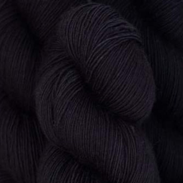 Skein of Madelinetosh Tosh Sock Sock weight yarn in the color Onyx (Black) for knitting and crocheting.