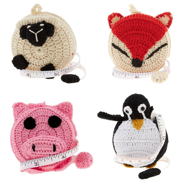 Four crochet animal tape measures are shown: sheep, fox, pig and penquin.
