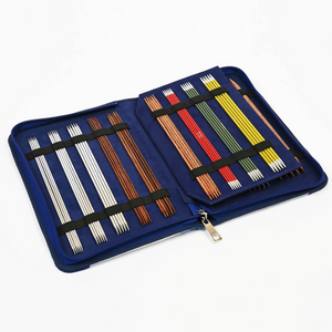 Knitter's Pride brand Blossom zippered, double pointed needle case. Perfectly sized to fit neatly in your bag or case, this compact needle case stores up to 16 sets of  double pointed needles (5 to a set). The suede like lining and secure elastic bands keep all in order.
