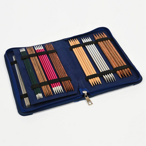 Knitter's Pride brand Blossom zippered, double pointed needle case. Perfectly sized to fit neatly in your bag or case, this compact needle case stores up to 16 sets of  double pointed needles (5 to a set). The suede like lining and secure elastic bands keep all in order.