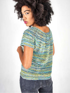 Woman modeling a sweater with a lace yoke knit in Berroco Summer Sesame Yarn, mint colorway.