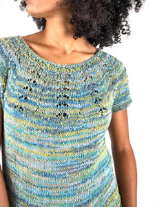 Woman modeling a sweater with a lace yoke knit in Berroco Summer Sesame Yarn, mint colorway.