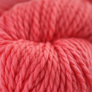 Skein of Cascade 128 Superwash Bulky weight yarn in the color Georgia Peach (Red) for knitting and crocheting.