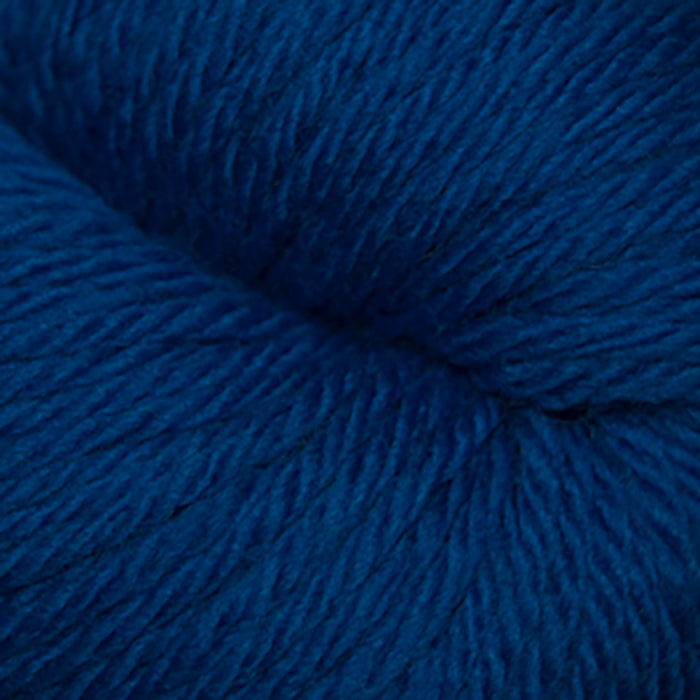 Skein of Cascade 220 Superwash Sport Sport weight yarn in the color Classic Blue (Blue) for knitting and crocheting.