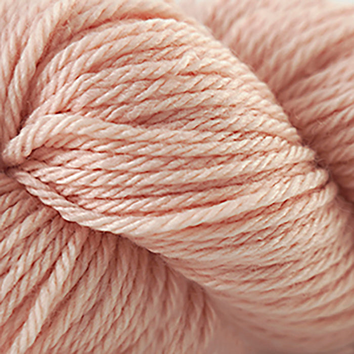 Skein of Cascade 220 Superwash Sport Sport weight yarn in the color Cream Puff (Orange) for knitting and crocheting.