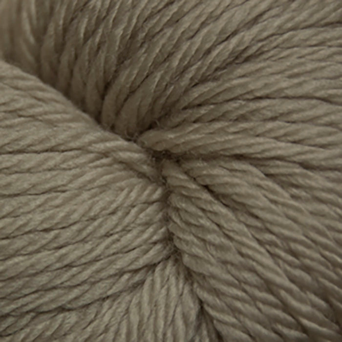 Skein of Cascade 220 Superwash Sport Sport weight yarn in the color Feather Grey (Tan) for knitting and crocheting.