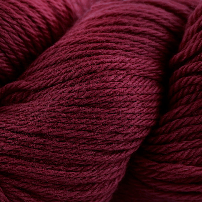 Skein of Cascade 220 Worsted weight yarn in the color Burgundy (Red) for knitting and crocheting.