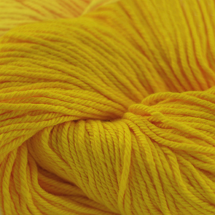 Skein of Cascade Nifty Cotton Worsted weight yarn in the color Gold (Yellow) for knitting and crocheting.