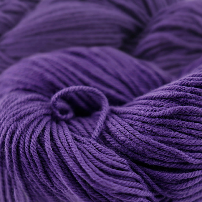 Skein of Cascade Nifty Cotton Worsted weight yarn in the color Purple (Purple) for knitting and crocheting.