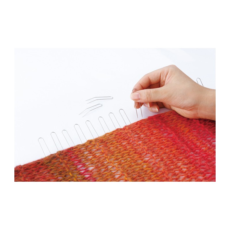 Woman using Clover Fork Blocking Pins on knitting.