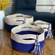 Load image into Gallery viewer, A set of three baskets crocheted from Cascade Yarns Nifty Cotton in Sapphire and Buff is shown.

