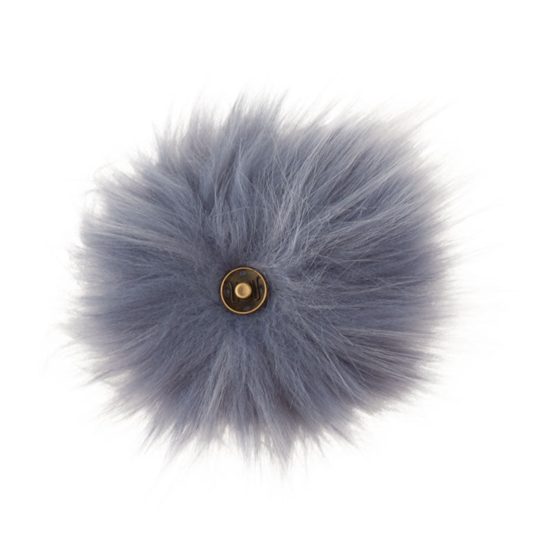 A soft and fuzzy, faux(fake) fur pom pom with a built-in snap on attachment that makes it easy to add to, and remove from, any project. This pom pom is a grey blue color.
