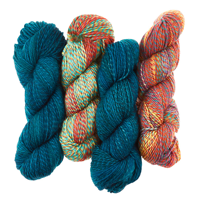 4 skeins of Cascade 220 Superwash Wave are shown in  Deep Sea (Blue) and Unicorn (Multi). The yarn is plied and has a long fading effect.