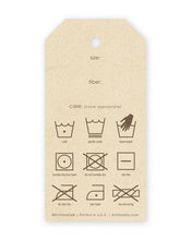 Load image into Gallery viewer, The back side of a gift tag is shown with care instruction symbols as well as fields for size, care, and fiber.
