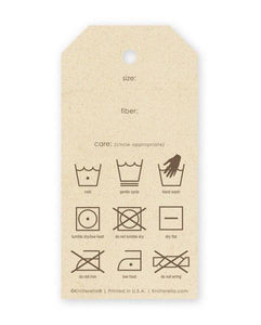 The back side of a gift tag is shown with care instruction symbols as well as fields for size, care, and fiber.