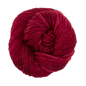 Skein of Madelinetosh TML Triple Twist Worsted weight yarn in color Coquette -Deux (Red) for knitting and crocheting.