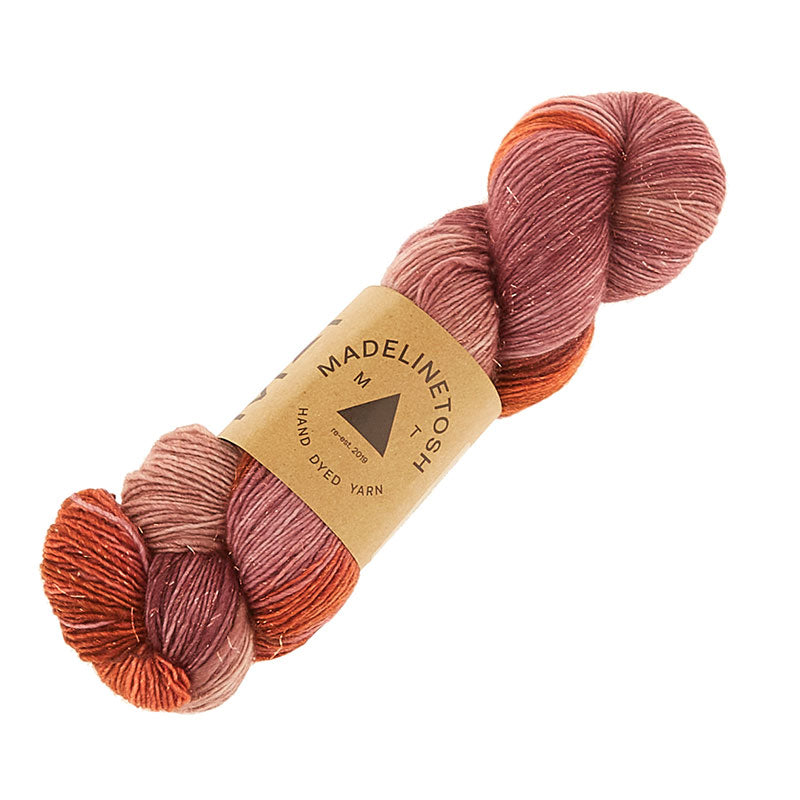 Skein of Madelinetosh TML + Copper Sock weight yarn in color Love the Wine Youre With (Purple) for knitting and crocheting.