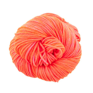 Skein of Madelinetosh TML Triple Twist Worsted weight yarn in color Neon Peach (Orange) for knitting and crocheting.