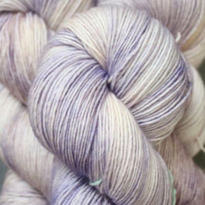 Skein of Madelinetosh Tosh Sock Sock weight yarn in the color Ametrine (Purple) for knitting and crocheting.