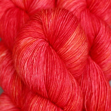 Load image into Gallery viewer, Skein of Madelinetosh Tosh Sock Sock weight yarn in the color Pop (Red) for knitting and crocheting.
