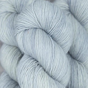 Skein of Madelinetosh Tosh Sock Sock weight yarn in the color Silver Fox (Gray) for knitting and crocheting.