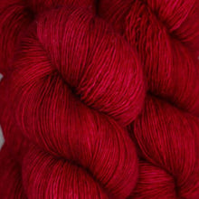 Load image into Gallery viewer, Skein of Madelinetosh Tosh Vintage Worsted weight yarn in the color Blood Runs Cold (Red) for knitting and crocheting.
