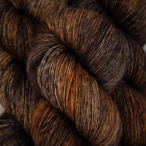 Skein of Madelinetosh Tosh Vintage Worsted weight yarn in the color Coffe Grounds (Brown) for knitting and crocheting.