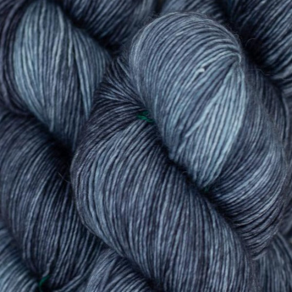Skein of Madelinetosh Tosh Vintage Worsted weight yarn in the color Dr. Zhivago's Sky (Gray) for knitting and crocheting.