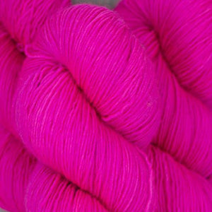 Skein of Madelinetosh Tosh Vintage Worsted weight yarn in the color Fluoro Rose (Pink) for knitting and crocheting.