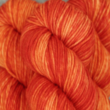 Load image into Gallery viewer, Skein of Madelinetosh Tosh Vintage Worsted weight yarn in the color GG Loves orange (Orange) for knitting and crocheting.
