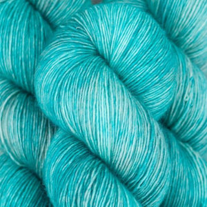 Skein of Madelinetosh Tosh Vintage Worsted weight yarn in the color Hosta Blue (Gray) for knitting and crocheting.