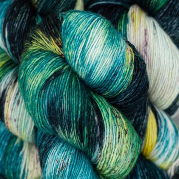 Skein of Madelinetosh Tosh Vintage Worsted weight yarn in the color Jaded Dreams (Green) for knitting and crocheting.