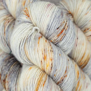 Skein of Madelinetosh Tosh Vintage Worsted weight yarn in the color Silver Lining (White) for knitting and crocheting.