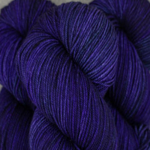 Skein of Madelinetosh Tosh Vintage Worsted weight yarn in the color The Feels (Purple) for knitting and crocheting.