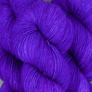 Skein of Madelinetosh Tosh Vintage Worsted weight yarn in the color Ultramarine Violet (Purple) for knitting and crocheting.