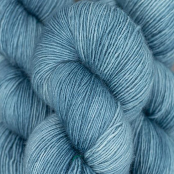 Skein of Madelinetosh Tosh Vintage Worsted weight yarn in the color Well Water (Blue) for knitting and crocheting.