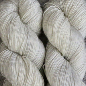 Skein of Madelinetosh Tosh Sock Sock weight yarn in the color Antler (White) for knitting and crocheting.