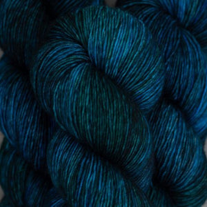Skein of Madelinetosh Tosh Vintage Worsted weight yarn in the color Cousteau (Blue) for knitting and crocheting.