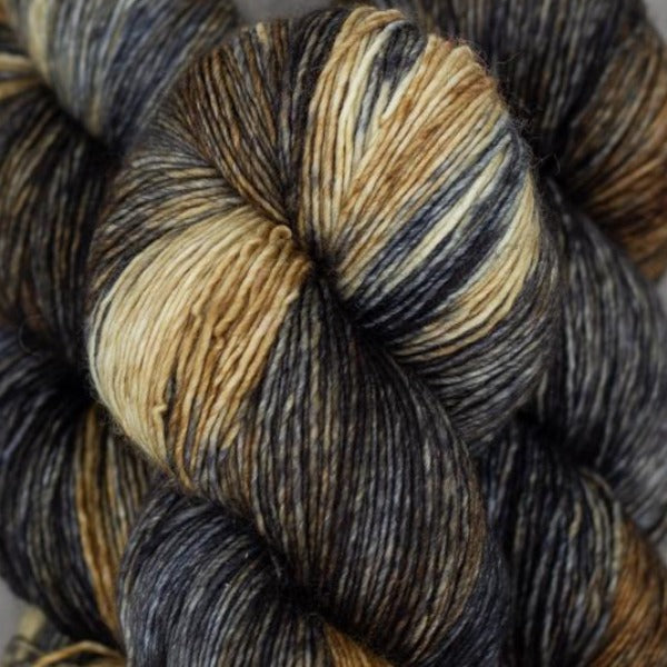 Skein of Madelinetosh Tosh Vintage Worsted weight yarn in the color Wolf (Brown) for knitting and crocheting.