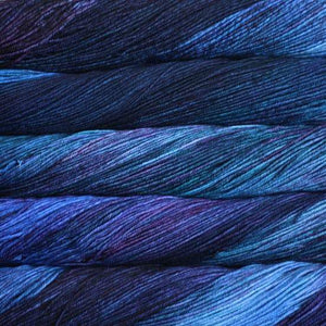 Skein of Malabrigo Arroyo Sport weight yarn in the color Whales Road (Blue) for knitting and crocheting.