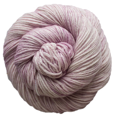 Skein of Malabrigo Caprino Sport weight yarn in color Valentina (Pink) for knitting and crocheting.