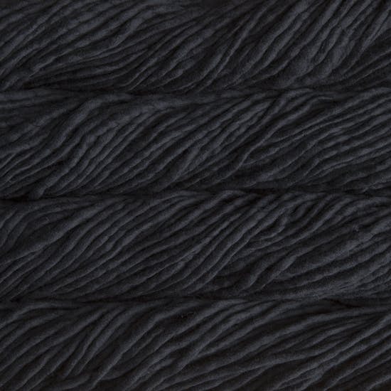 Skein of Malabrigo Rasta Super Bulky weight yarn in the color Black (Black) for knitting and crocheting.