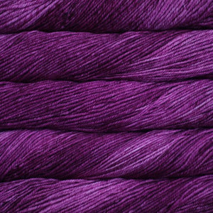 Skein of Malabrigo Rios Worsted weight yarn in the color Hollyhock (Purple) for knitting and crocheting.