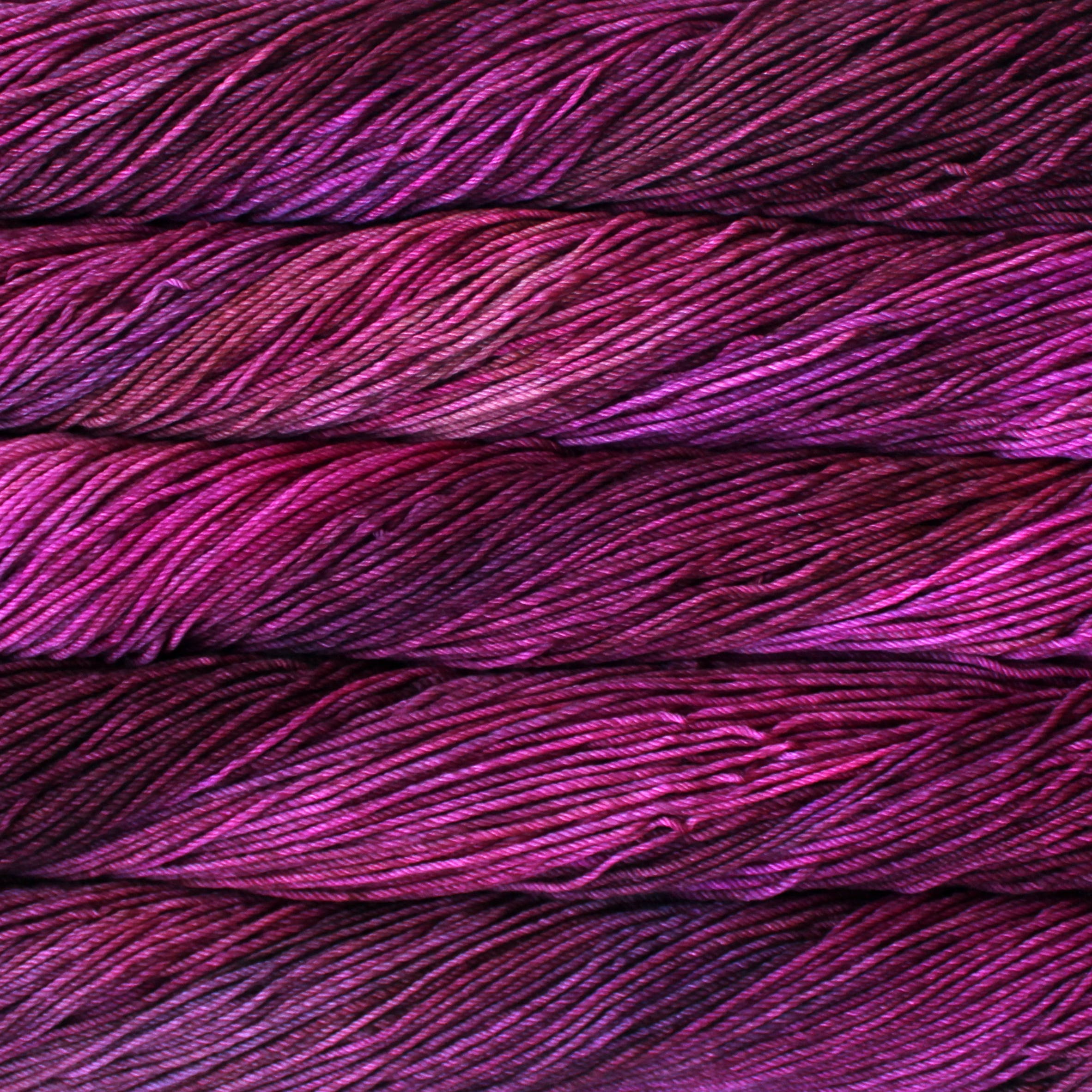 Skein of Malabrigo Rios Worsted weight yarn in the color Magenta (Pink) for knitting and crocheting.
