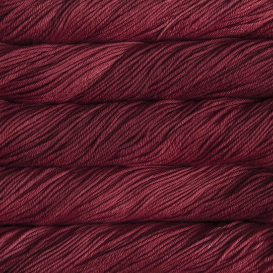 Skein of Malabrigo Rios Worsted weight yarn in the color Ravelry Red (Pink) for knitting and crocheting.