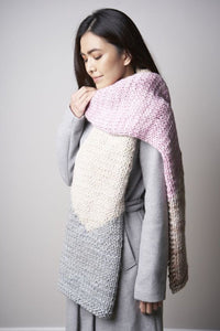 A scarf is shown in light pink, cream and gray.