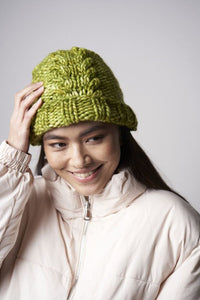 The Quinn Hat, a green textured hat knit in Malabrigo Rasta, is shown.