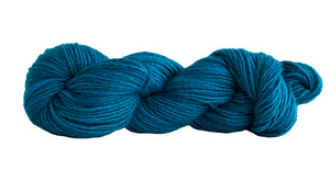Skein of Manos del Uruguay Silk Blend DK weight yarn in the color Juniper (Blue) for knitting and crocheting.
