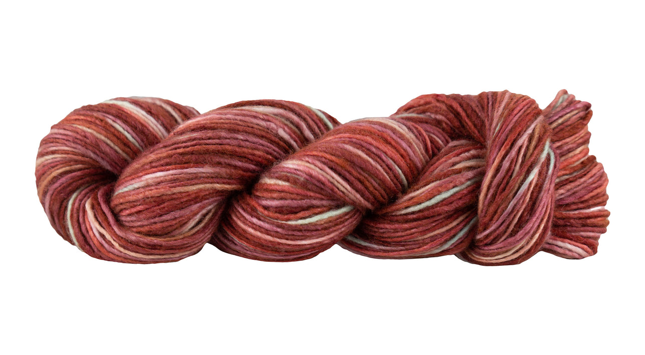 Skein of Manos del Uruguay Silk Blend Space-Dyed DK weight yarn in the color Killim (Red) for knitting and crocheting.