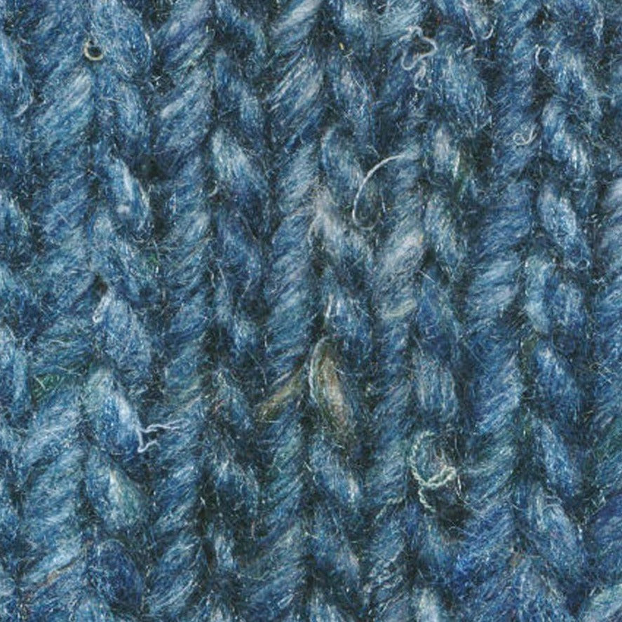 Skein of Noro Silk Garden Solo Worsted weight yarn in the color Suita (Blue) for knitting and crocheting.